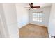 This bedroom has neutral carpet, white walls, a window and a ceiling fan at 8541 W Pershing Ave, Peoria, AZ 85381