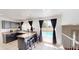 Well-lit kitchen with dark cabinets, breakfast bar, and view of the backyard pool at 8541 W Pershing Ave, Peoria, AZ 85381