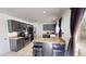 Spacious kitchen featuring dark cabinets, stainless steel appliances, and an adjacent dining area at 8541 W Pershing Ave, Peoria, AZ 85381