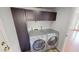 Well-equipped laundry room with stainless steel washer and dryer set and storage at 8541 W Pershing Ave, Peoria, AZ 85381