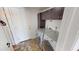 Functional laundry room with washer, dryer, and overhead storage cabinets at 8541 W Pershing Ave, Peoria, AZ 85381