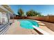 Backyard pool with diving board surrounded by a patio and block fence for privacy at 8541 W Pershing Ave, Peoria, AZ 85381