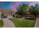 A beautifully landscaped backyard with artificial turf and covered patio, perfect for entertaining at 9345 W Robin Ln, Peoria, AZ 85383