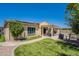 A landscaped backyard with artificial grass, covered patio, solar panels, and desert landscaping at 9345 W Robin Ln, Peoria, AZ 85383