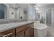Elegant bathroom featuring dual vanities with granite countertops and a large soaking tub at 9345 W Robin Ln, Peoria, AZ 85383