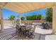 Inviting covered patio with a dining table, outdoor seating, and a grill overlooking the pool at 9345 W Robin Ln, Peoria, AZ 85383
