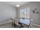 Cozy dining area features a rustic wooden table with seating for six, complemented by bright natural light at 9345 W Robin Ln, Peoria, AZ 85383