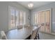 Elegant dining room featuring a large wood table, six upholstered chairs, and plantation shutters for natural light at 9345 W Robin Ln, Peoria, AZ 85383