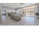 Open-concept living area with tile floors, large sectional, and seamless indoor-outdoor transition at 9345 W Robin Ln, Peoria, AZ 85383