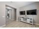 Bright living area features a sleek white media console and modern tile flooring at 9345 W Robin Ln, Peoria, AZ 85383