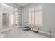 Versatile playroom offers lots of natural light with neutral walls and tile flooring at 9345 W Robin Ln, Peoria, AZ 85383