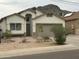 Single-Gathering home featuring neutral stucco, low-maintenance desert landscaping, and an attached two-car garage at 10006 N 7Th Pl, Phoenix, AZ 85020
