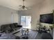 Inviting living room with vaulted ceiling, ceiling fan, and sliding glass doors to the backyard at 10006 N 7Th Pl, Phoenix, AZ 85020