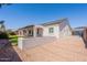 A view of the home's back exterior featuring a covered patio, and a gravel area at 1062 N Robin Ln, Mesa, AZ 85213