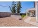 A backyard with a planter, gravel, grass, and a covered patio at 1062 N Robin Ln, Mesa, AZ 85213