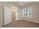 Bedroom with neutral walls, shuttered windows, and access to the bathroom at 1062 N Robin Ln, Mesa, AZ 85213