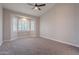 Bright bedroom boasts vaulted ceiling, neutral walls, plush carpet, and large bay window with shutter for natural light at 1062 N Robin Ln, Mesa, AZ 85213