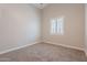 Bright bedroom boasts vaulted ceiling, neutral walls, plush carpet, and large window with shutter for natural light at 1062 N Robin Ln, Mesa, AZ 85213