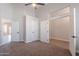 Large bedroom with multiple doors and windows, plush carpeting and tall ceiling make this room feel airy and open at 1062 N Robin Ln, Mesa, AZ 85213