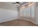 Bright bedroom featuring wood floors, white wainscotting, and plantation shutters at 1062 N Robin Ln, Mesa, AZ 85213