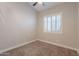 Bright carpeted bedroom with a window at 1062 N Robin Ln, Mesa, AZ 85213