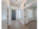 Bright entryway boasting modern lighting fixtures, sleek flooring, and sophisticated plantation shutters at 1062 N Robin Ln, Mesa, AZ 85213