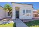 Close exterior view of the front entrance framed by an arch and palm trees at 1062 N Robin Ln, Mesa, AZ 85213