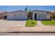 Exterior view of home including the walkway to the front door, a two-car garage, and green lawn at 1062 N Robin Ln, Mesa, AZ 85213