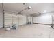 Spacious garage featuring ample storage cabinets, epoxy floors, and room for multiple vehicles at 1062 N Robin Ln, Mesa, AZ 85213