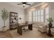 Well-lit home office with a large desk, comfortable chair, and ample shelving, ideal for productivity and focus at 1062 N Robin Ln, Mesa, AZ 85213