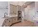 Kitchen area showcasing gray cabinets, stainless steel appliances, and bright wood flooring at 1062 N Robin Ln, Mesa, AZ 85213