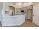Bright kitchen boasts a large island with a white countertop and stainless steel appliances and fixtures at 1062 N Robin Ln, Mesa, AZ 85213