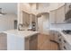 Open kitchen highlighting gray cabinets, a stainless steel double oven, and a central island at 1062 N Robin Ln, Mesa, AZ 85213