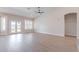 Open-concept living room with hardwood flooring, high ceilings, and access to the backyard at 1062 N Robin Ln, Mesa, AZ 85213