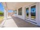 A covered patio with white pillars and a view of the backyard with grass and a wall at 1062 N Robin Ln, Mesa, AZ 85213