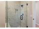 Modern shower with marble tile, built-in niche, glass enclosure and rainfall shower head at 1062 N Robin Ln, Mesa, AZ 85213