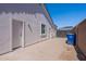 A view of the home's side exterior featuring a door to the backyard and a gravel area at 1062 N Robin Ln, Mesa, AZ 85213