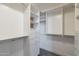 Large walk-in closet featuring custom shelving, drawers, and ample storage space at 1062 N Robin Ln, Mesa, AZ 85213