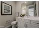 Stylish bathroom with a modern vanity, decorative art, and contemporary fixtures and finishes at 11300 N Casa Dega Dr # 1019, Surprise, AZ 85388