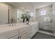 Luxurious bathroom with double vanity, marble accents, and a glass-enclosed shower at 11300 N Casa Dega Dr # 1019, Surprise, AZ 85388