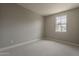 Neutral bedroom featuring carpet, a window offering outside views, and electrical outlets at 11300 N Casa Dega Dr # 1019, Surprise, AZ 85388