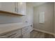Well-organized laundry room with countertop, cabinets, and connections for appliances at 11300 N Casa Dega Dr # 1019, Surprise, AZ 85388