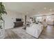 Open-concept living area with hardwood floors and a view of the dining and kitchen spaces at 11300 N Casa Dega Dr # 1019, Surprise, AZ 85388