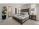 Serene main bedroom featuring a plush bed, soft lighting, and a glimpse into the en-suite bathroom at 11300 N Casa Dega Dr # 1019, Surprise, AZ 85388