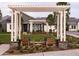 Stylish outdoor seating area framed by a pergola and lush greenery at 11300 N Casa Dega Dr # 1019, Surprise, AZ 85388