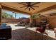 Outdoor living area featuring a pool, covered patio with ceiling fan, and an outdoor grill at 12601 W San Miguel Ave, Litchfield Park, AZ 85340