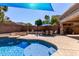 Beautiful backyard featuring a pool, dining area with patio umbrella, and a shady canopy at 12601 W San Miguel Ave, Litchfield Park, AZ 85340