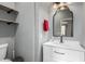 This is a bathroom with floating shelves and a sink with a black faucet and modern vanity mirror at 12601 W San Miguel Ave, Litchfield Park, AZ 85340