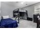 Bedroom showcasing a loft bed with desk space, and gray walls, offering a functional and stylish design at 12601 W San Miguel Ave, Litchfield Park, AZ 85340