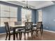 Dining room with modern chandelier, a table set for six and blue accent wall at 12601 W San Miguel Ave, Litchfield Park, AZ 85340
